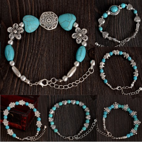 Turquoise and Tibetan silver bracelet with simbolic pendants