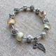 Pulsera con charms cristal rosa y blanco y colgante con ala y corazon