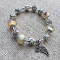 Pulsera con charms cristal rosa y blanco y colgante con ala y corazon