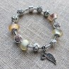 Pulsera con charms cristal rosa y blanco y colgante con ala y corazon