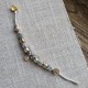 Pulsera con charms dorados y plateados y cierre dorada