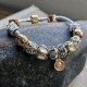 Bracelet with Gold and Silver Charms and a Gold Clasp