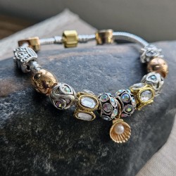 Pulsera con charms dorados y plateados y cierre dorada