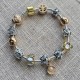 Pulsera con charms dorados y plateados y cierre dorada